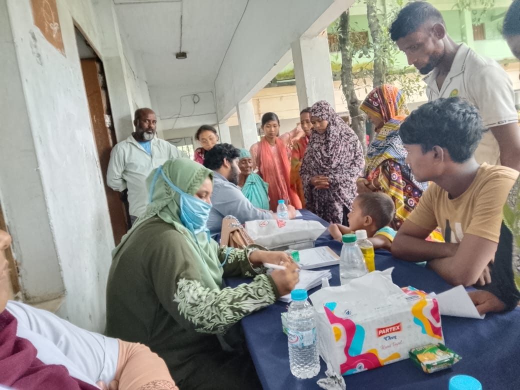 Community members gathered around the registration and checkup desk at the free medical camp